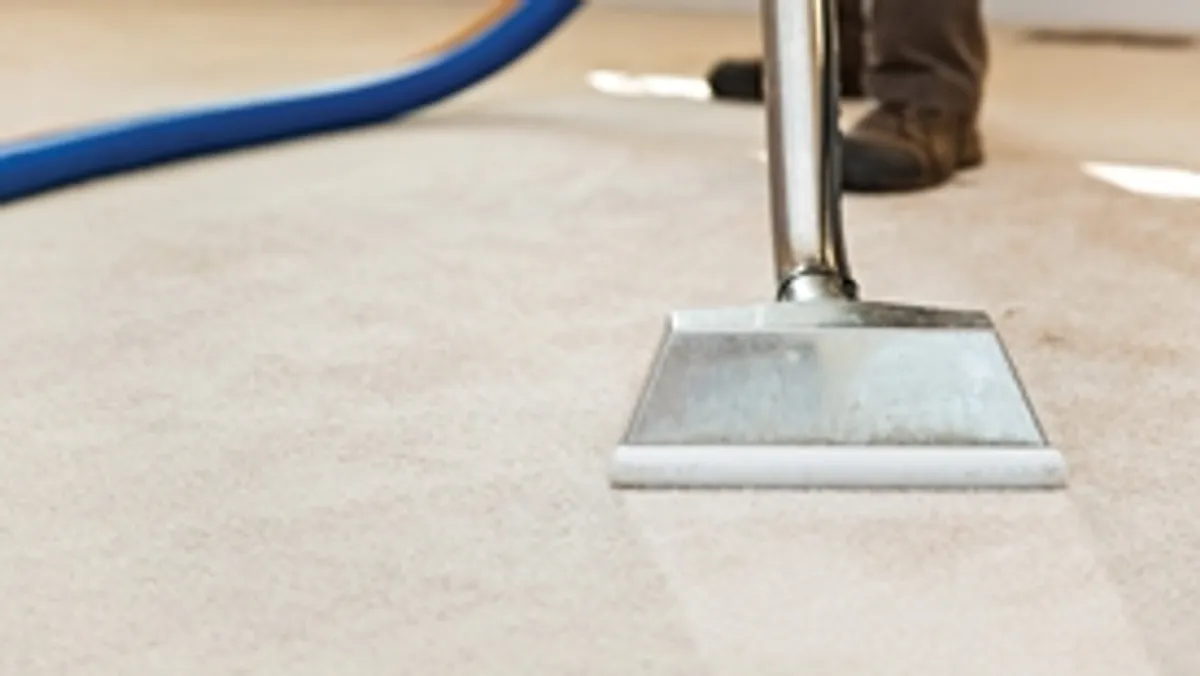 Carpet cleaning wand head gliding over a light carpet during hot-water extraction, Oklahoma City, OK.
